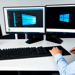 A professional in a modest business shirt and trousers, seated at a sleek, minimalist desk. On the desk, a high-performance desktop PC setup features two large monitors, each clearly displaying a distinct operating system interface, such as Windows on one and a Linux distribution on the other, subtly highlighting seamless multi-boot functionality. The individual is engaged with the screens, emphasizing the efficiency and technological capability. The background is a modern, clean office space bathed in natural light. fully clothed, appropriate attire, safe for work, professional, perfect anatomy, correct proportions, natural pose, well-formed hands, proper finger count, natural body proportions, high quality, studio lighting, sharp focus.